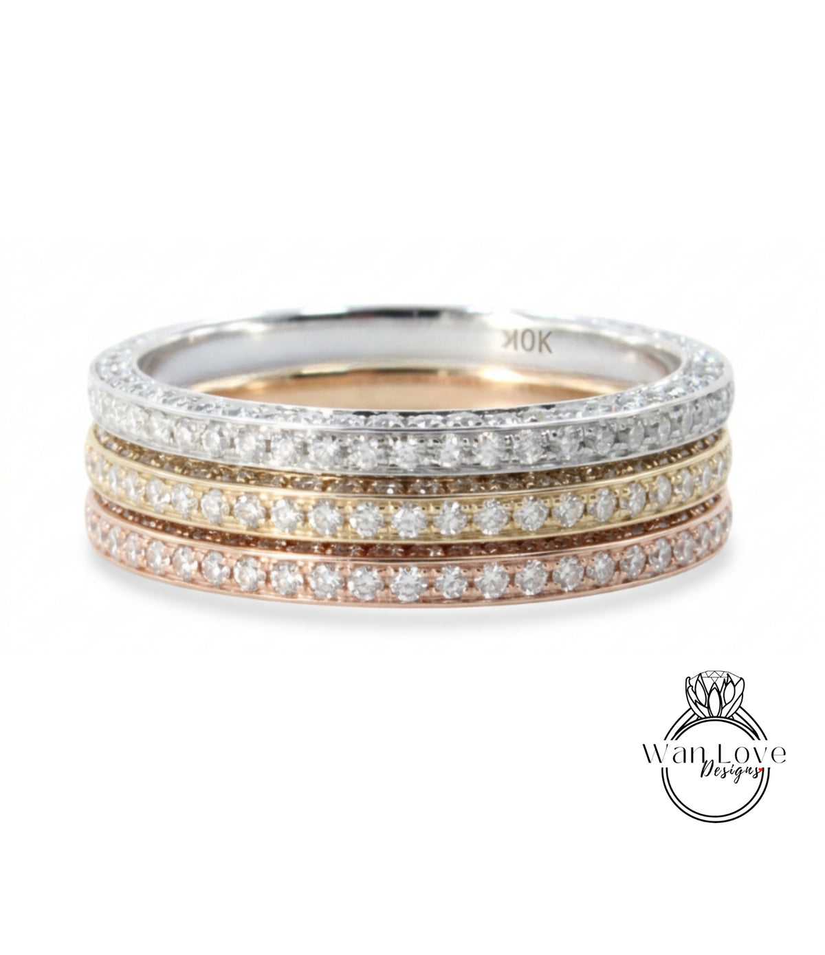 A ring with a band of diamonds in various colors, including silver, gold, and pink.