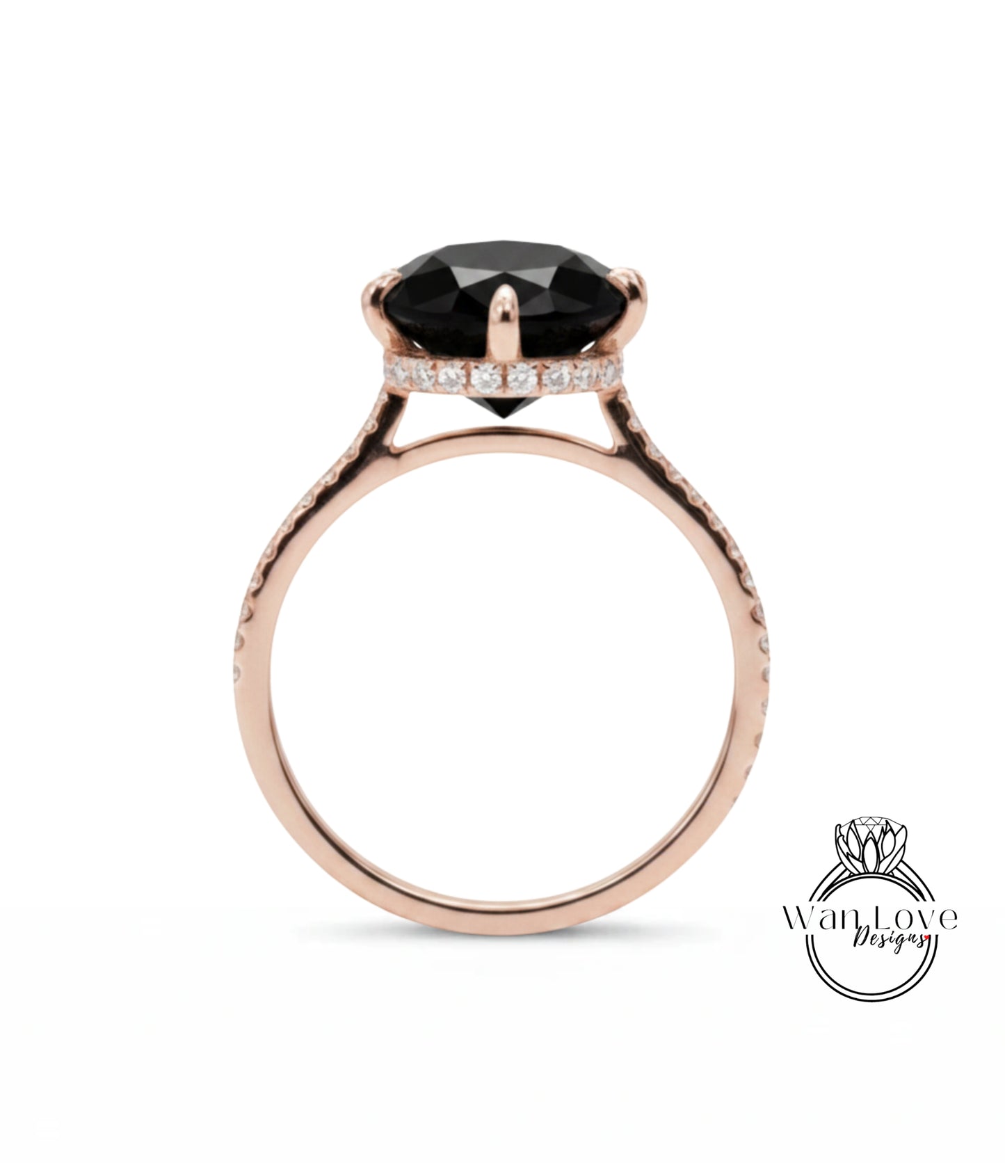 A rose gold engagement ring with a large black gemstone, such as a diamond, set in the center.
