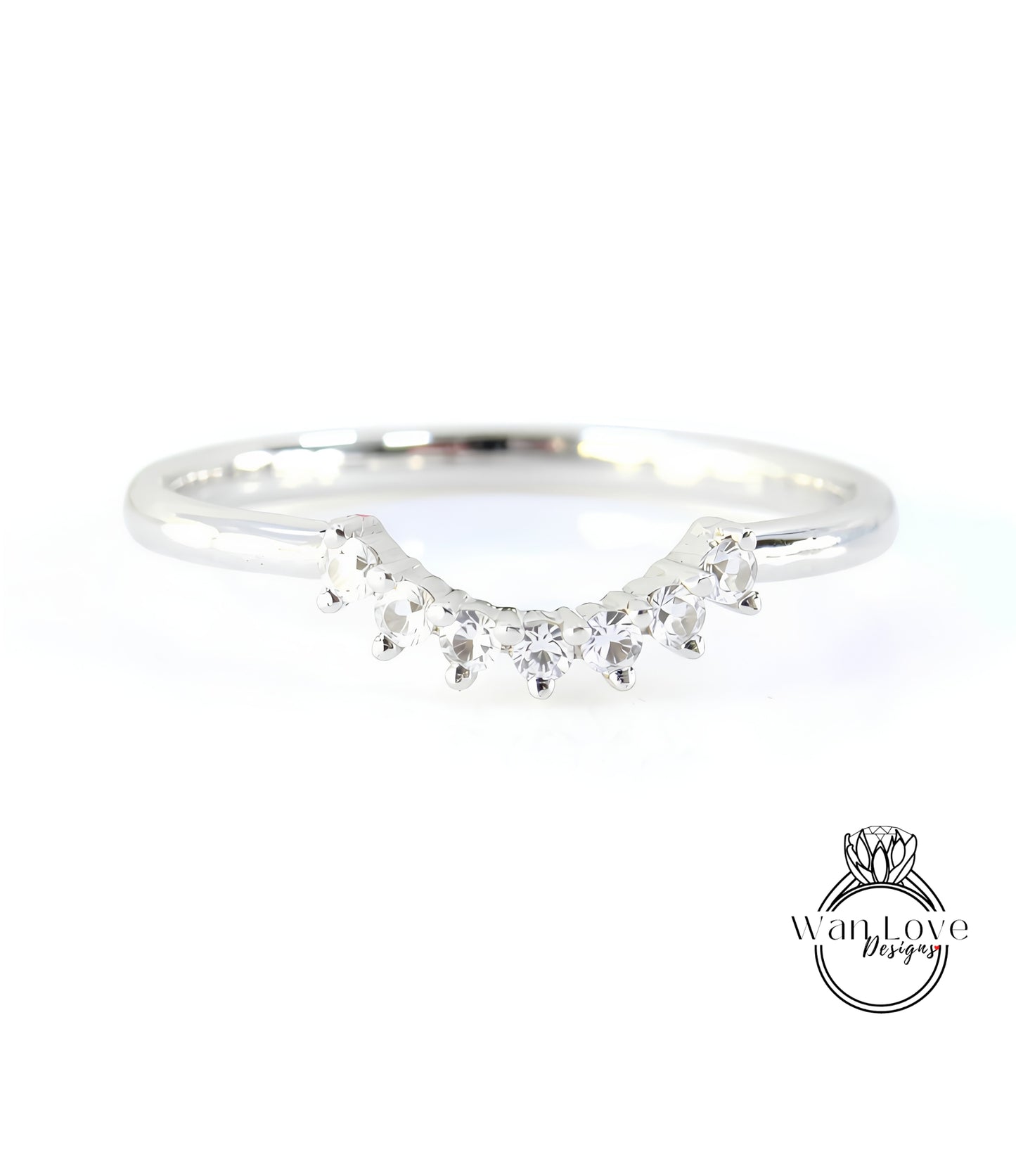 A silver ring with a row of small diamonds set in the center.