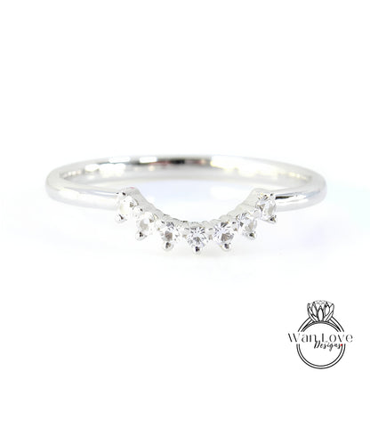 A silver ring with a row of small diamonds set in the center.