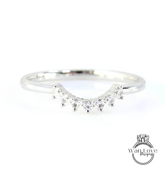 A silver ring with a row of small diamonds set in the center.