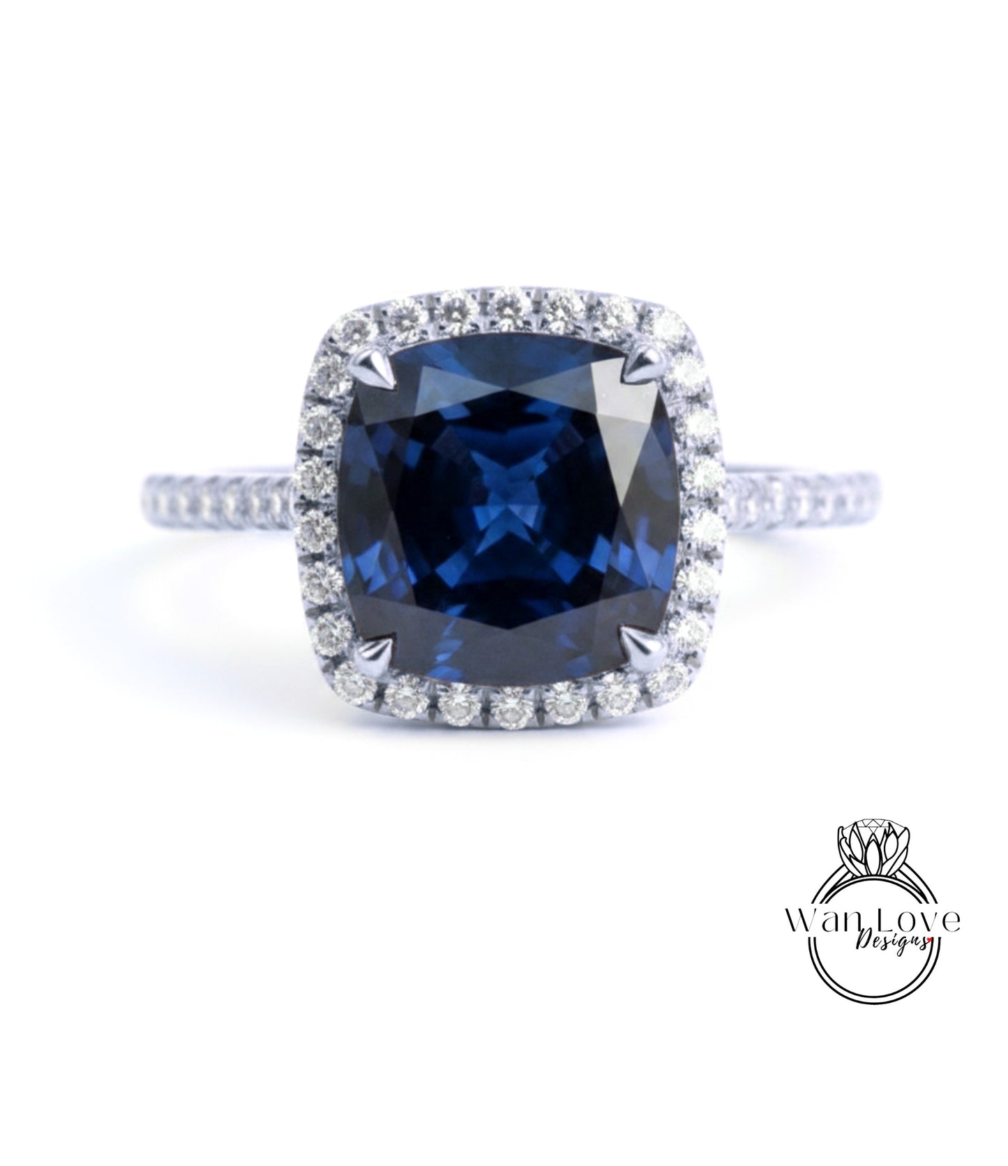 A stunning blue gemstone ring with a halo of diamonds around the center stone.