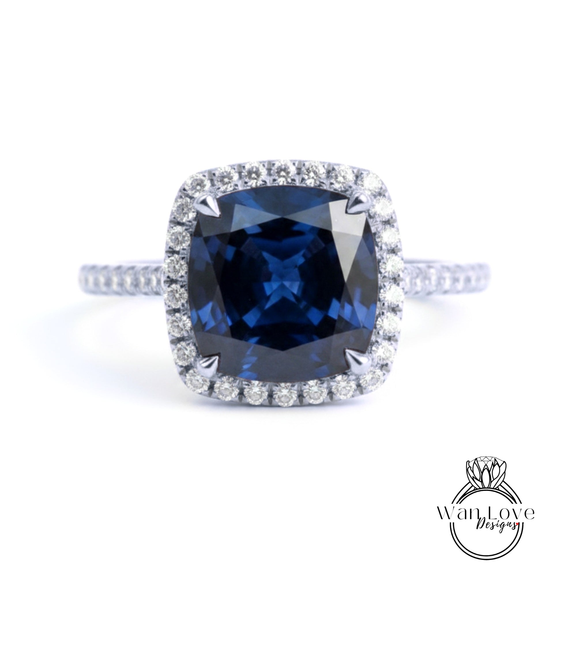 A stunning blue gemstone ring with a halo of diamonds around the center stone.