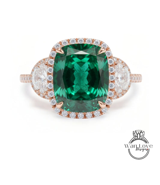 A large, oval-shaped green gemstone set in a halo of smaller diamonds, surrounded by a ring band with smaller diamonds.