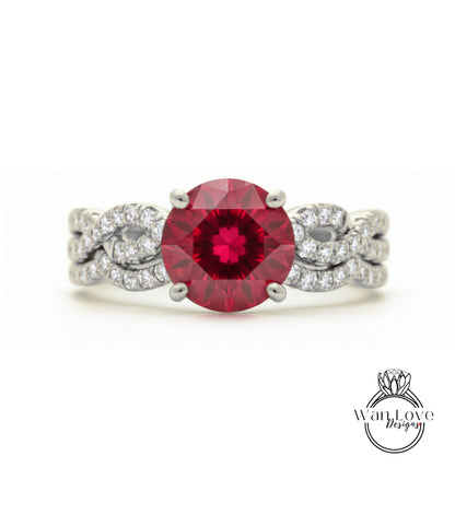A stunning engagement ring with a large, deep red gemstone set in a silver band adorned with smaller diamonds.