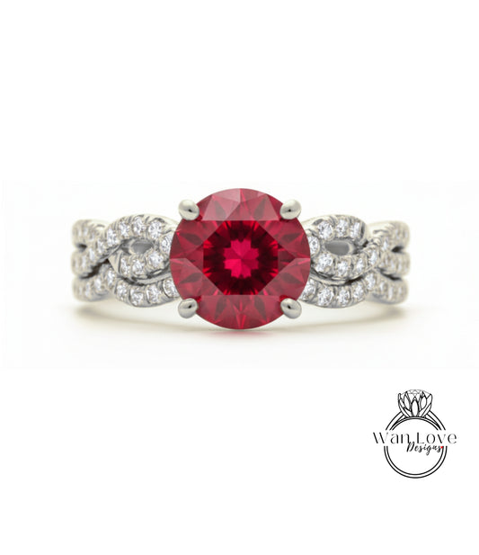 A stunning engagement ring with a large, deep red gemstone set in a silver band adorned with smaller diamonds.