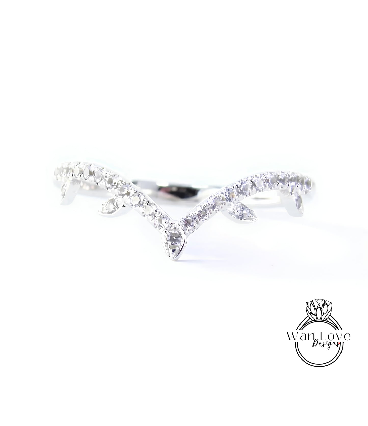A close-up view of a diamond ring with a unique design, featuring a central diamond surrounded by smaller diamonds arranged in a curved pattern.