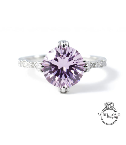 A close-up of a beautiful purple gemstone ring with a silver band and intricate detailing.