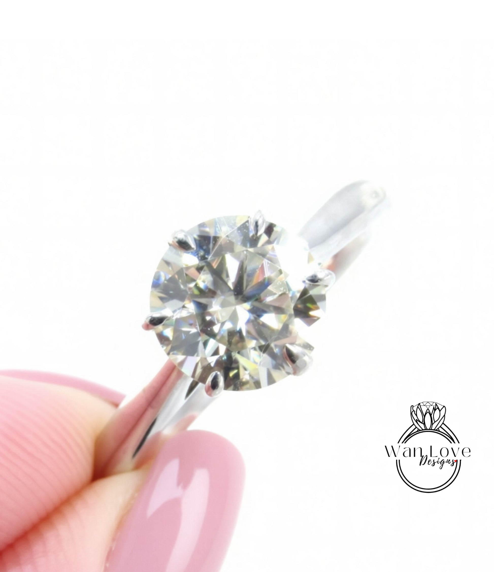 A close-up image of a person's hand holding a diamond engagement ring, with the ring's diamond visible in the center of the image.