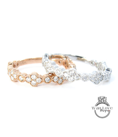 two rings with a combination of gold and silver tones, adorned with numerous small diamonds.