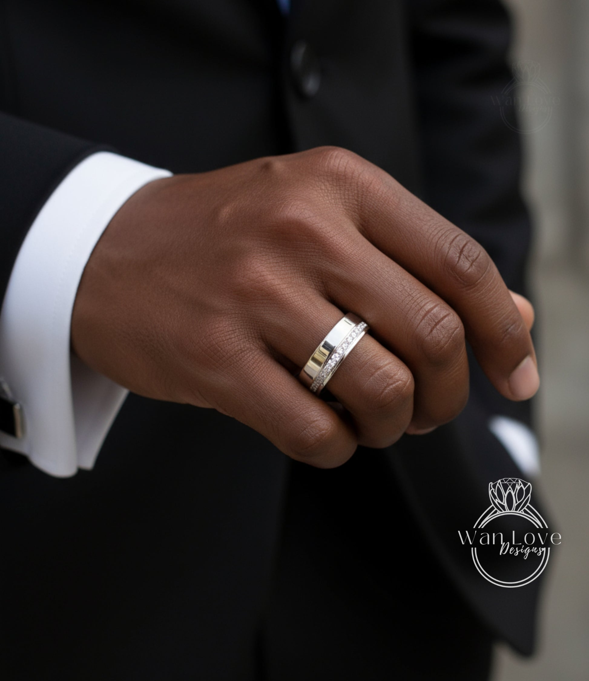 A close-up of a person's hand wearing a silver wedding ring.