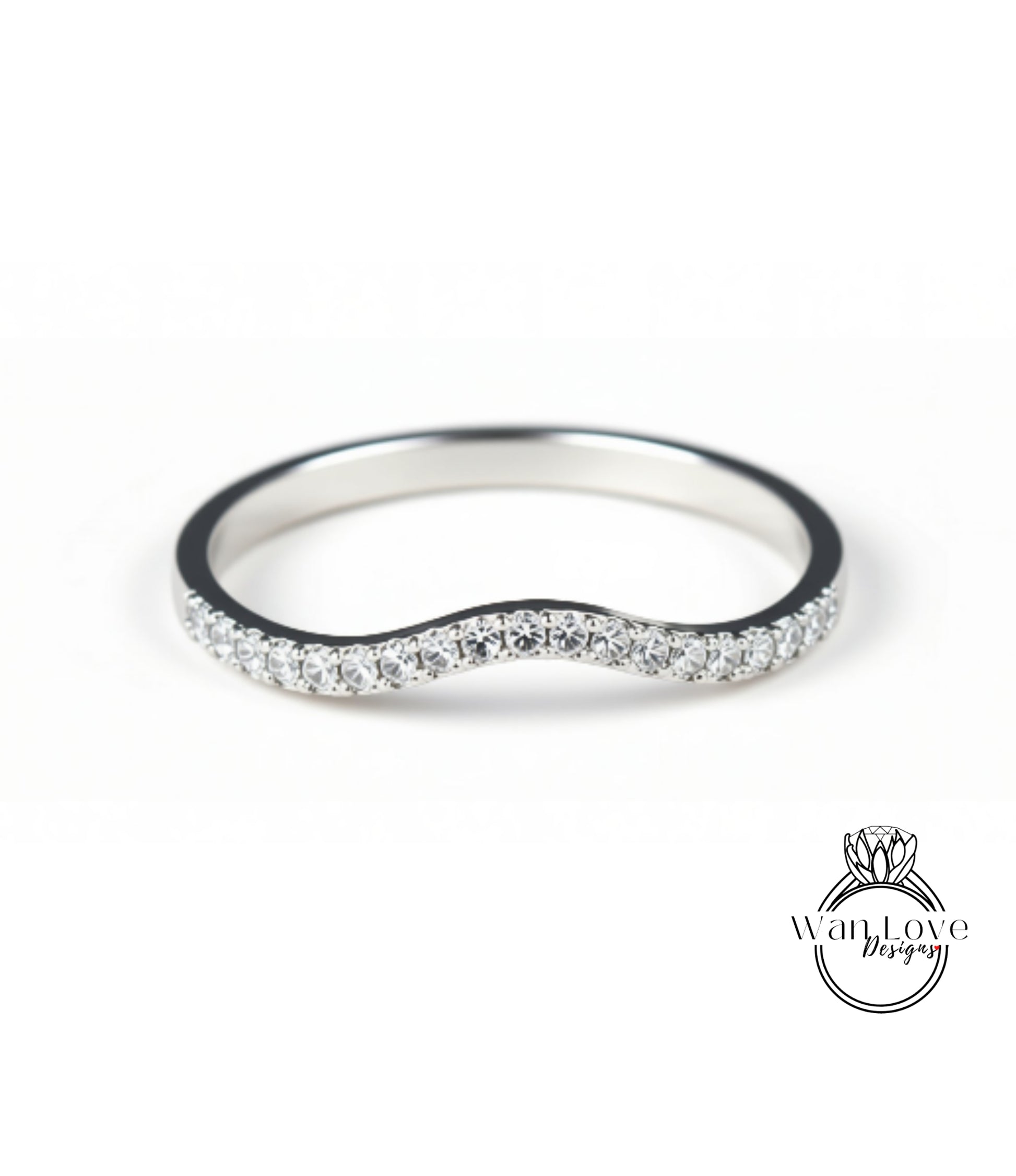A silver ring with a wavy band and small diamonds set in it.