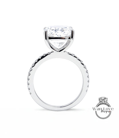 A large, clear diamond engagement ring with a large central diamond and a smaller diamond band around the base.