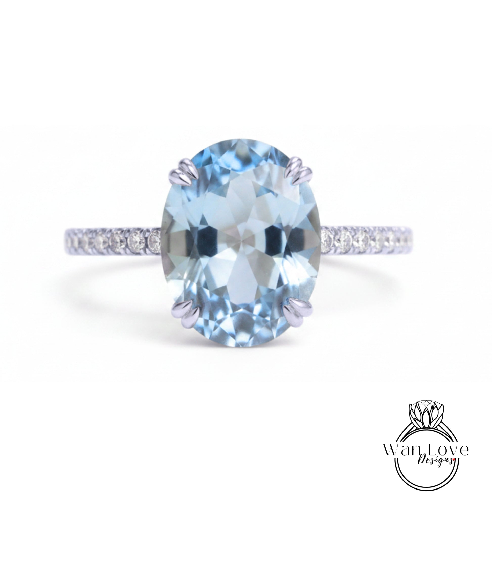 A beautiful blue gemstone ring with a band of smaller diamonds.