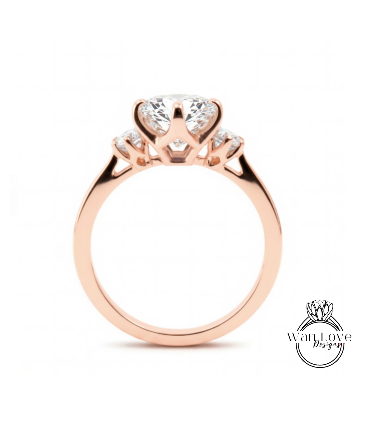 A rose gold engagement ring with a large central diamond and smaller diamonds on either side.