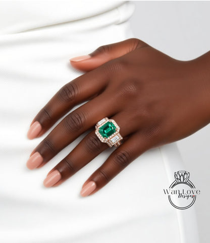 A close-up of a hand wearing a ring with a large, green gemstone.