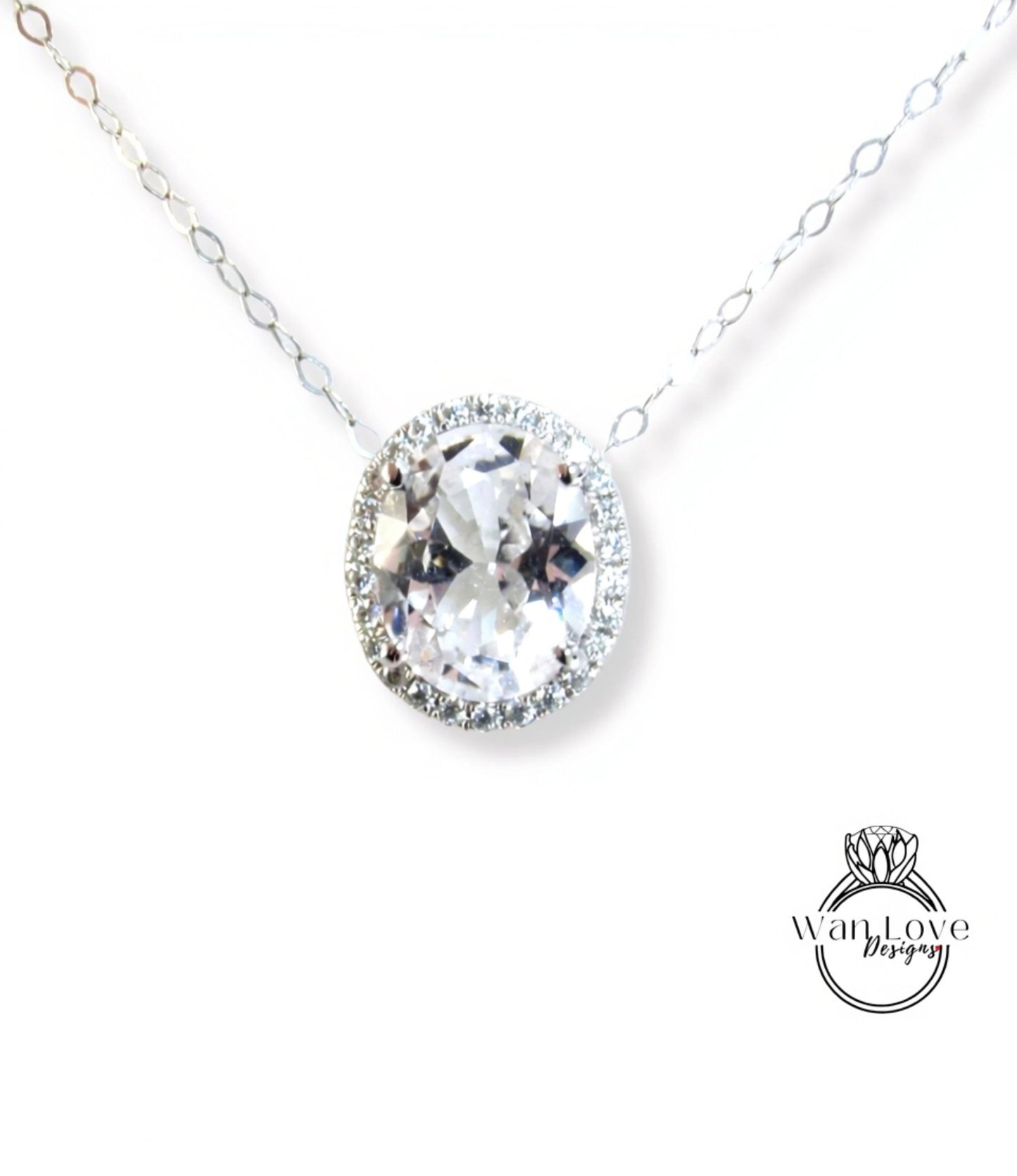 A necklace with a large, clear gemstone pendant, surrounded by a halo of smaller diamonds.
