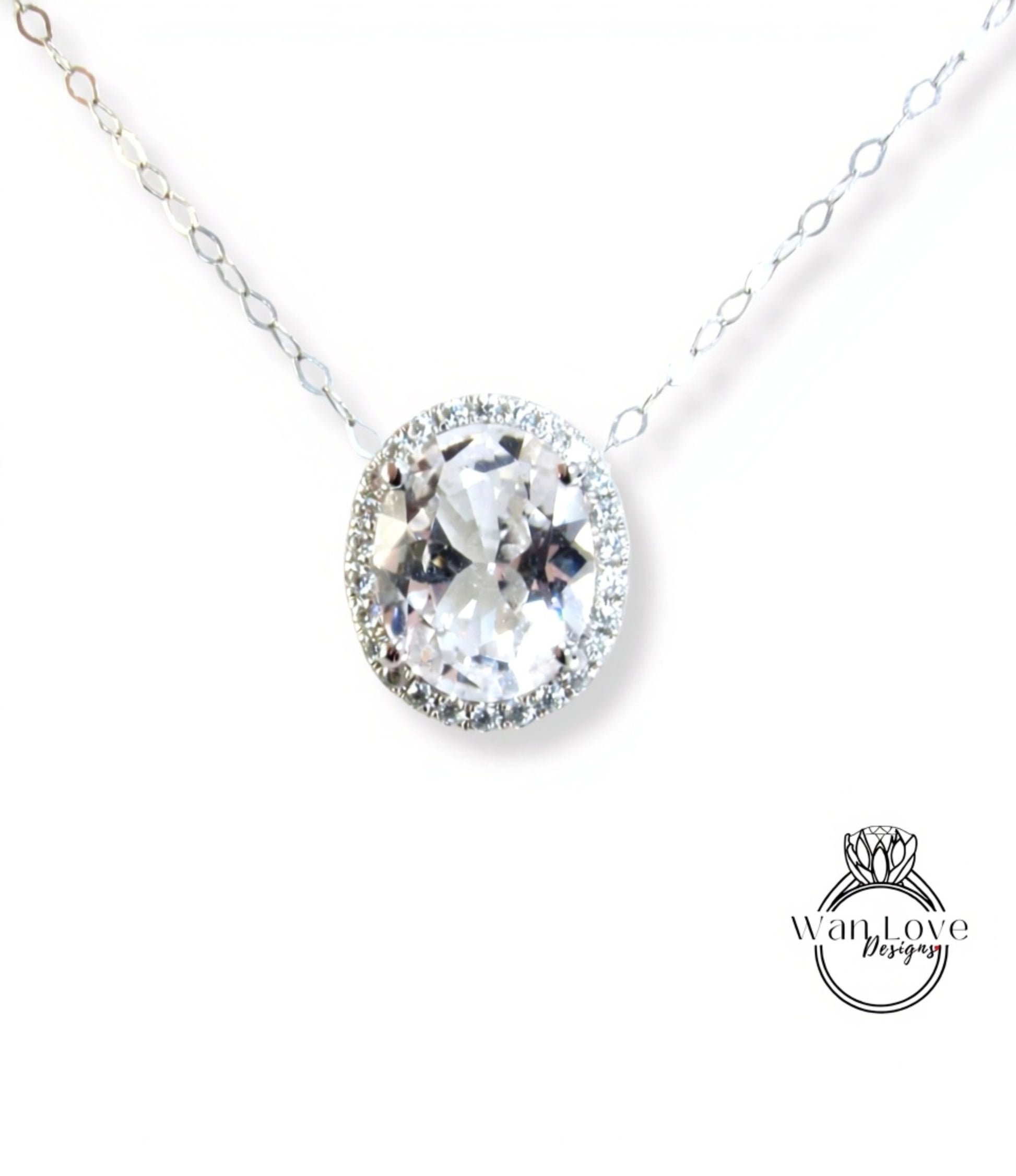 A necklace with a large, clear gemstone pendant, surrounded by a halo of smaller diamonds.