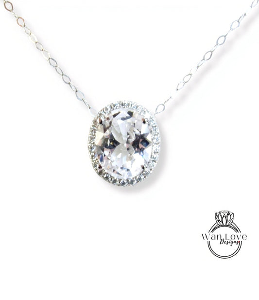 A necklace with a large, clear gemstone pendant, surrounded by a halo of smaller diamonds.
