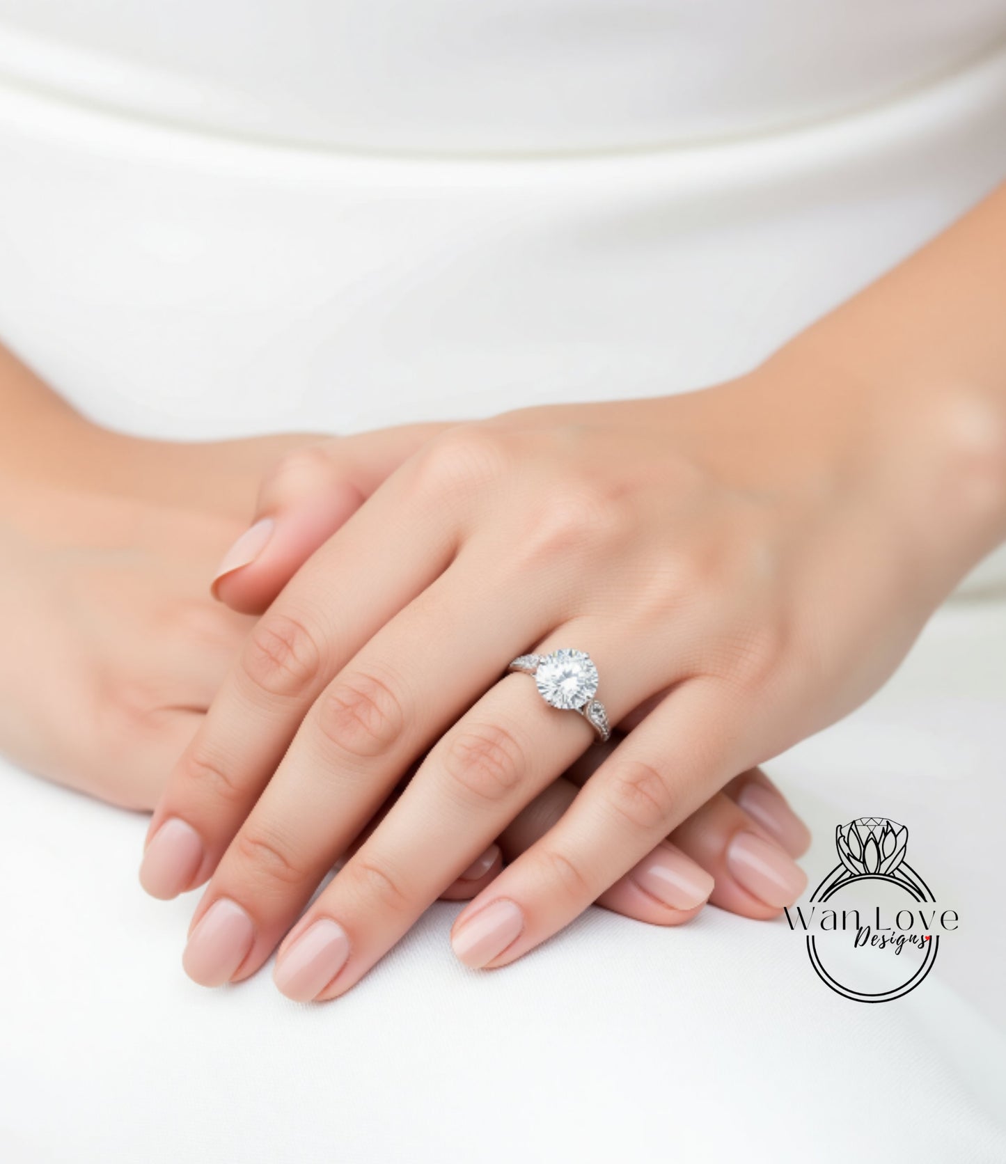 A close-up of a person's hand wearing a diamond engagement ring.