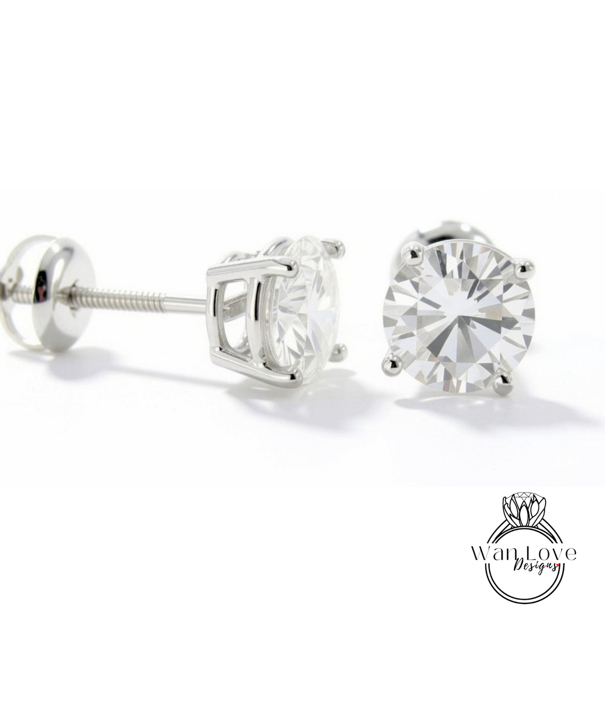 A pair of elegant silver earrings with a large, clear diamond set in the center, resting on a white background.