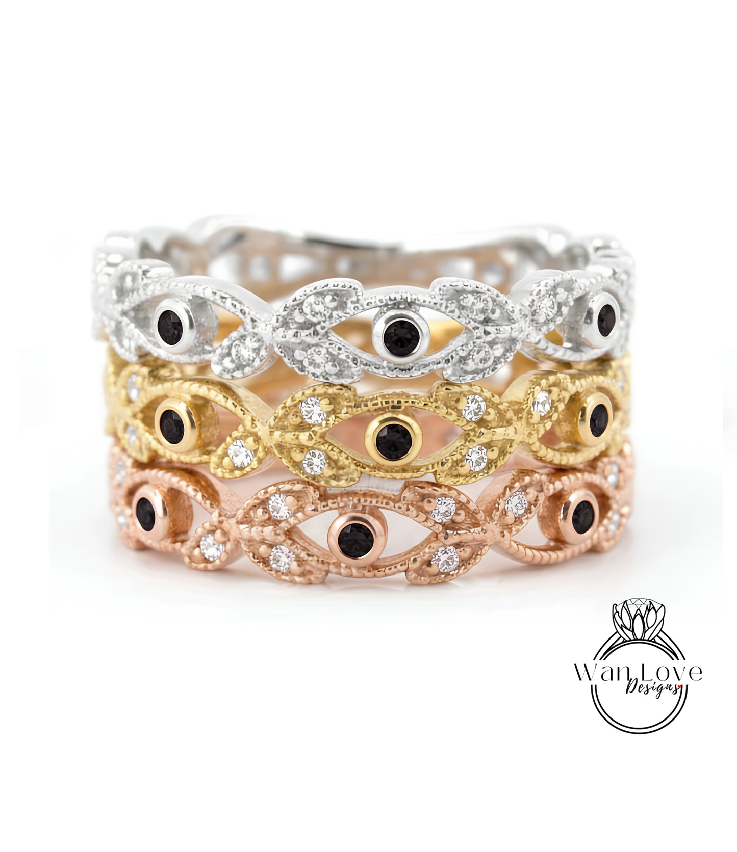A ring with multiple layers of colored gemstone designs, featuring a combination of silver, gold, and rose gold tones.