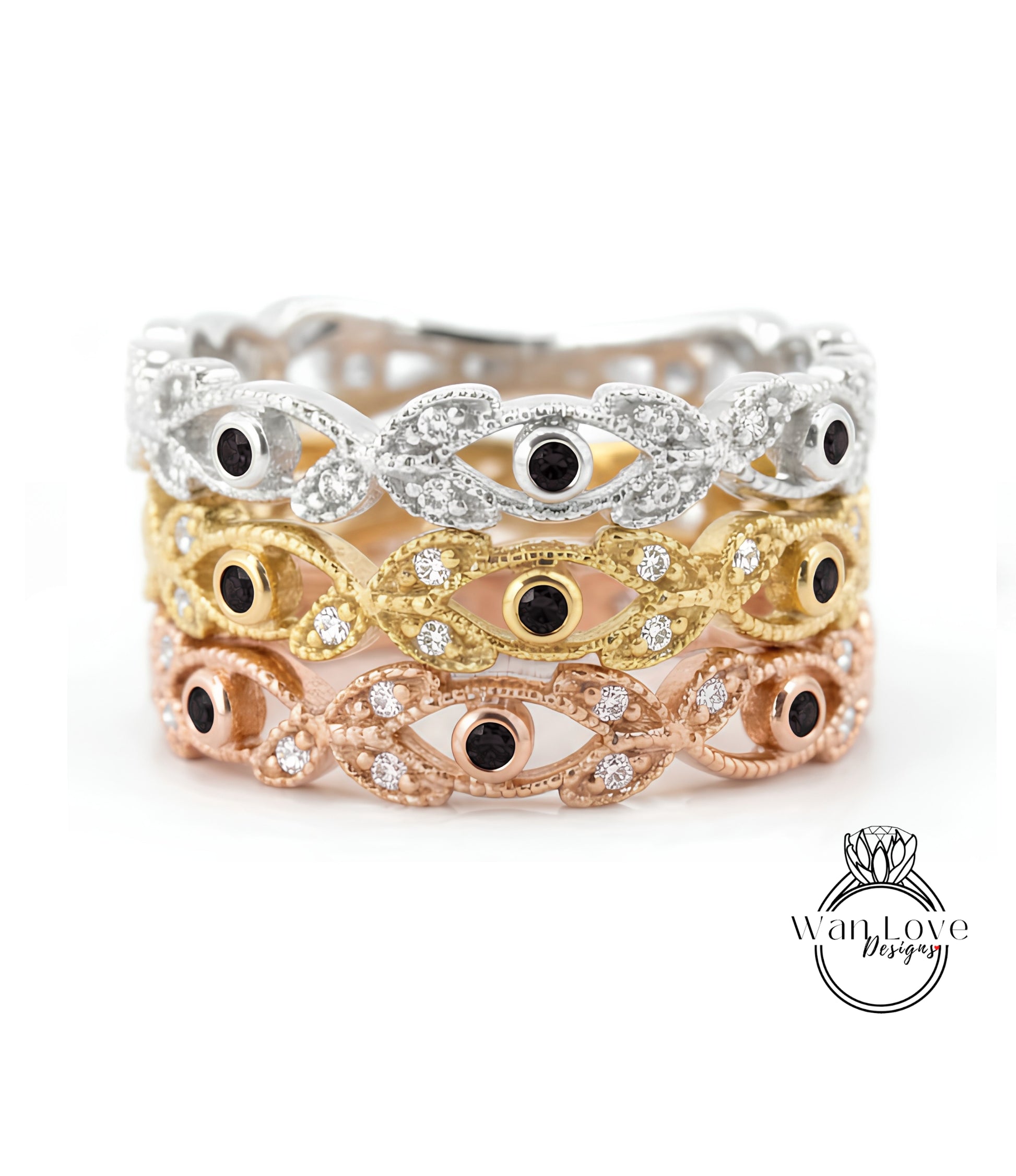 A ring with multiple layers of colored gemstone designs, featuring a combination of silver, gold, and rose gold tones.