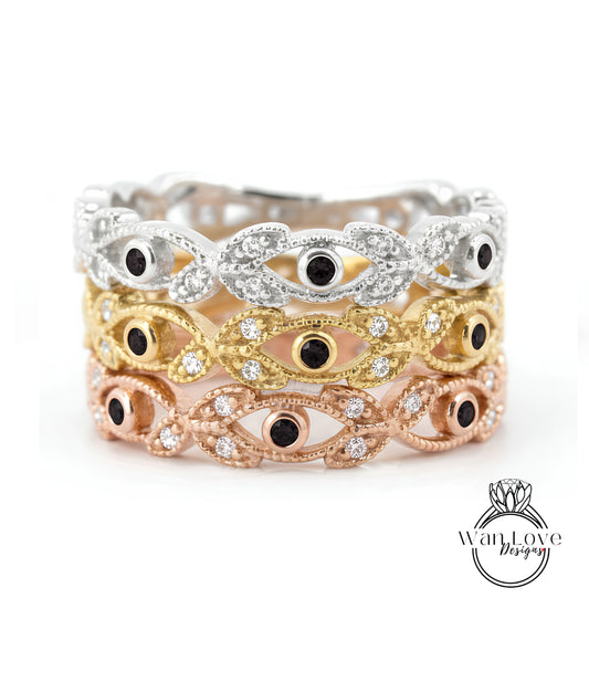 A ring with multiple layers of colored gemstone designs, featuring a combination of silver, gold, and rose gold tones.