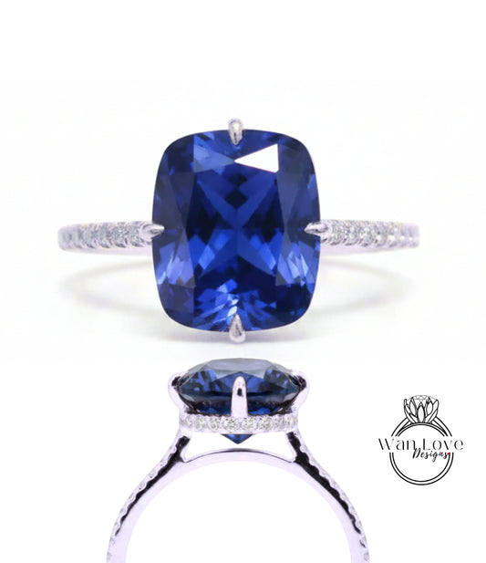 A stunning blue sapphire engagement ring with a large central gemstone surrounded by smaller diamonds set in a silver band.