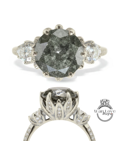 a silver ring with a large, irregularly shaped gray diamond as the centerpiece. The ring is adorned with smaller diamonds set in the floral design.