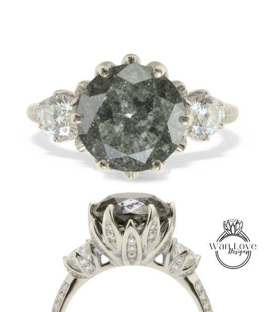 a silver ring with a large, irregularly shaped gray diamond as the centerpiece. The ring is adorned with smaller diamonds set in the floral design.