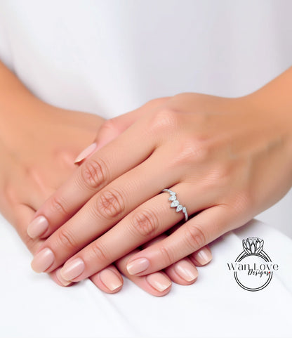 A close-up image of a person's hands with a diamond ring on the ring finger.