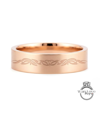 A gold-colored ring with a decorative design on the surface.