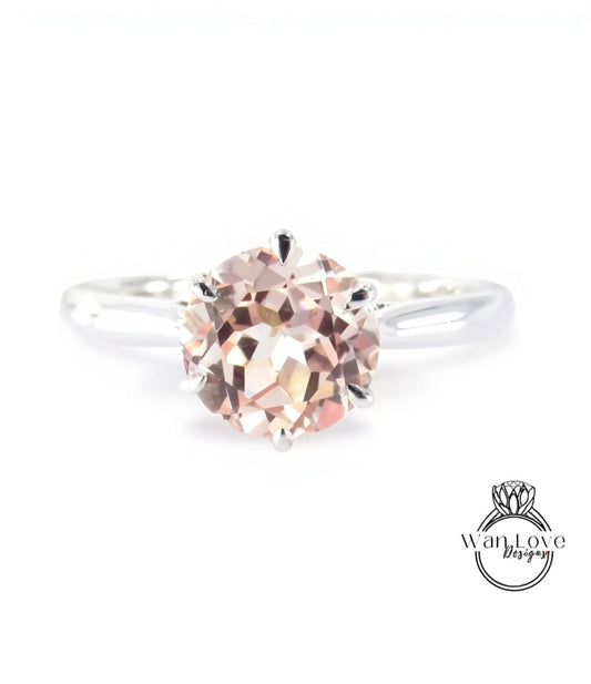 A close-up image of a diamond engagement ring with a large, round, and clear gemstone set in a silver band.