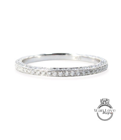 A silver band ring with a row of small diamonds set in it.