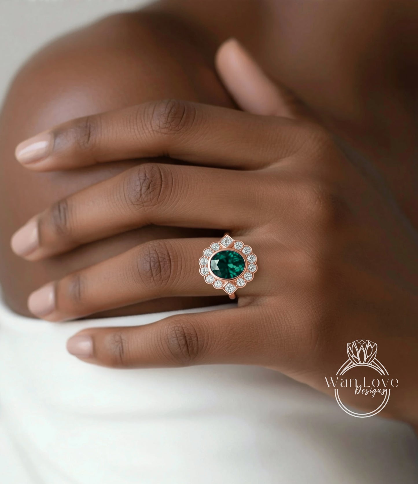 A close-up of a person's hand wearing a ring with a large, green gemstone surrounded by smaller diamonds.