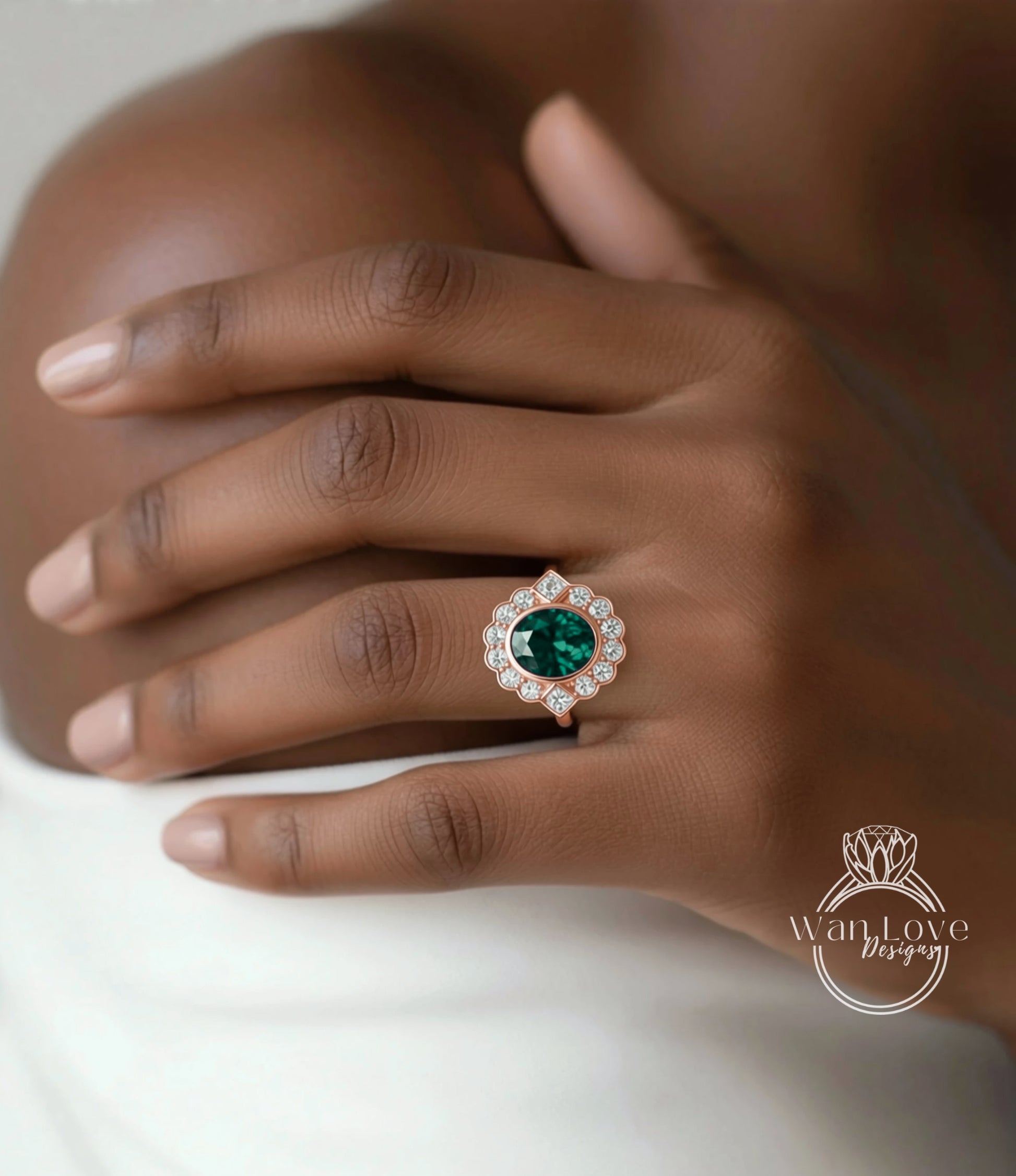 A close-up of a person's hand wearing a ring with a large, green gemstone surrounded by smaller diamonds.