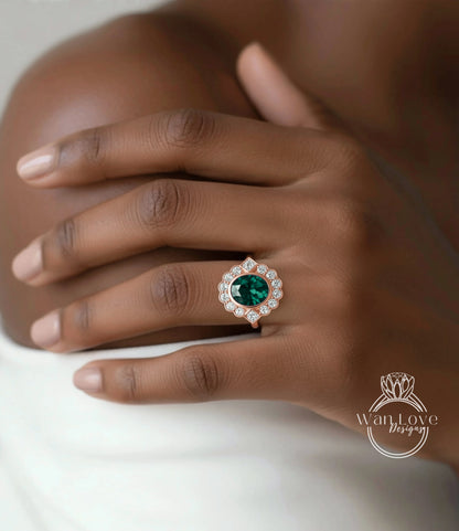 A close-up of a person's hand wearing a ring with a large, green gemstone surrounded by smaller diamonds.