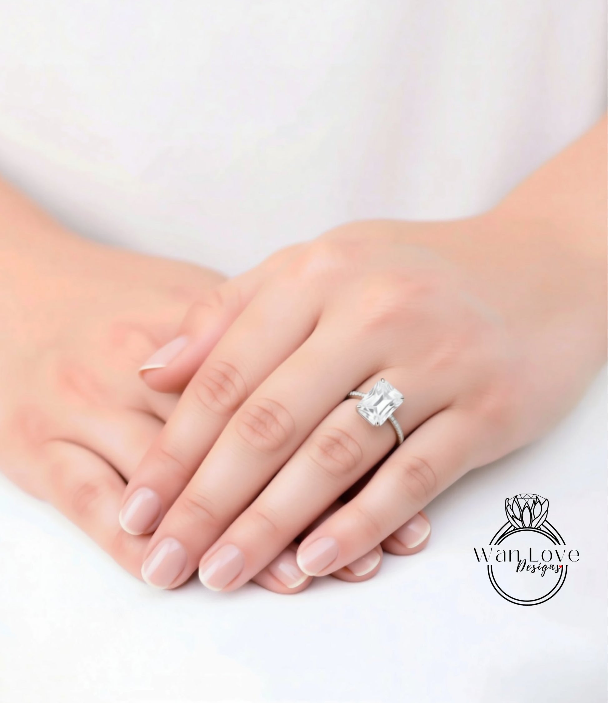 A close-up of a person's hands wearing a large diamond engagement ring.