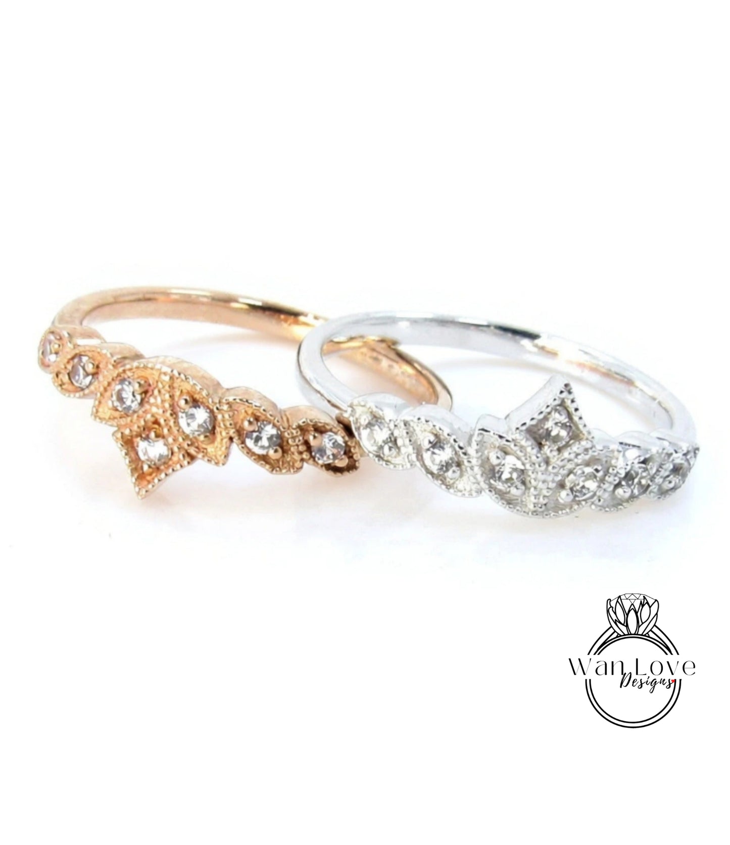 Two rings with intricate designs and sparkling gemstones are displayed against a white background.