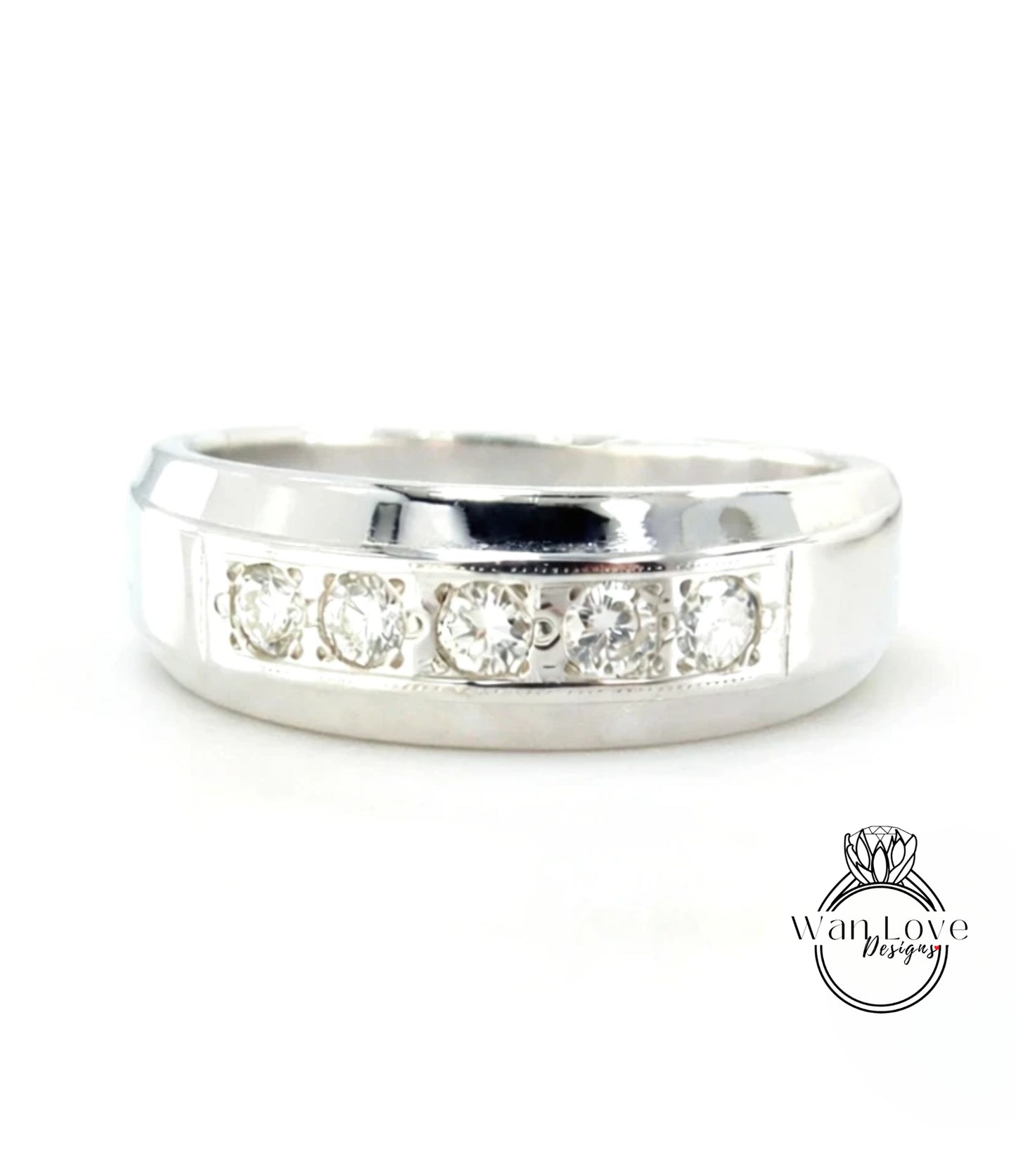 A silver ring with a row of four diamonds set in the band.