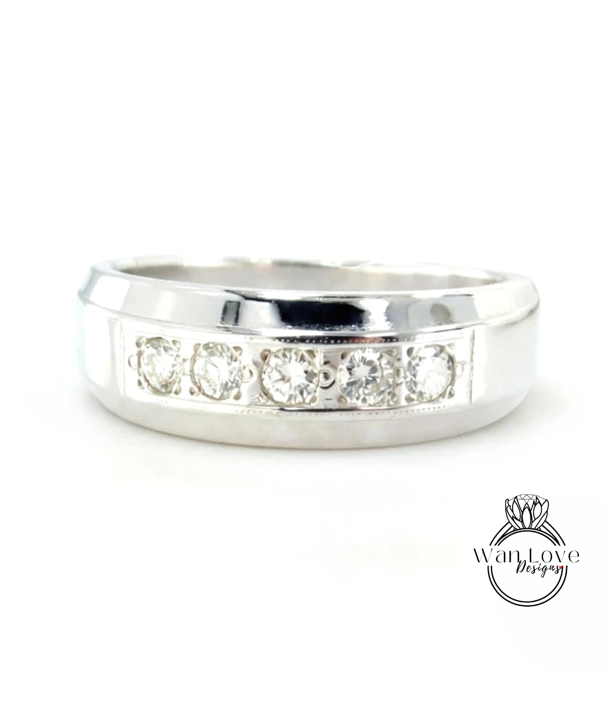A silver ring with a row of four diamonds set in the band.