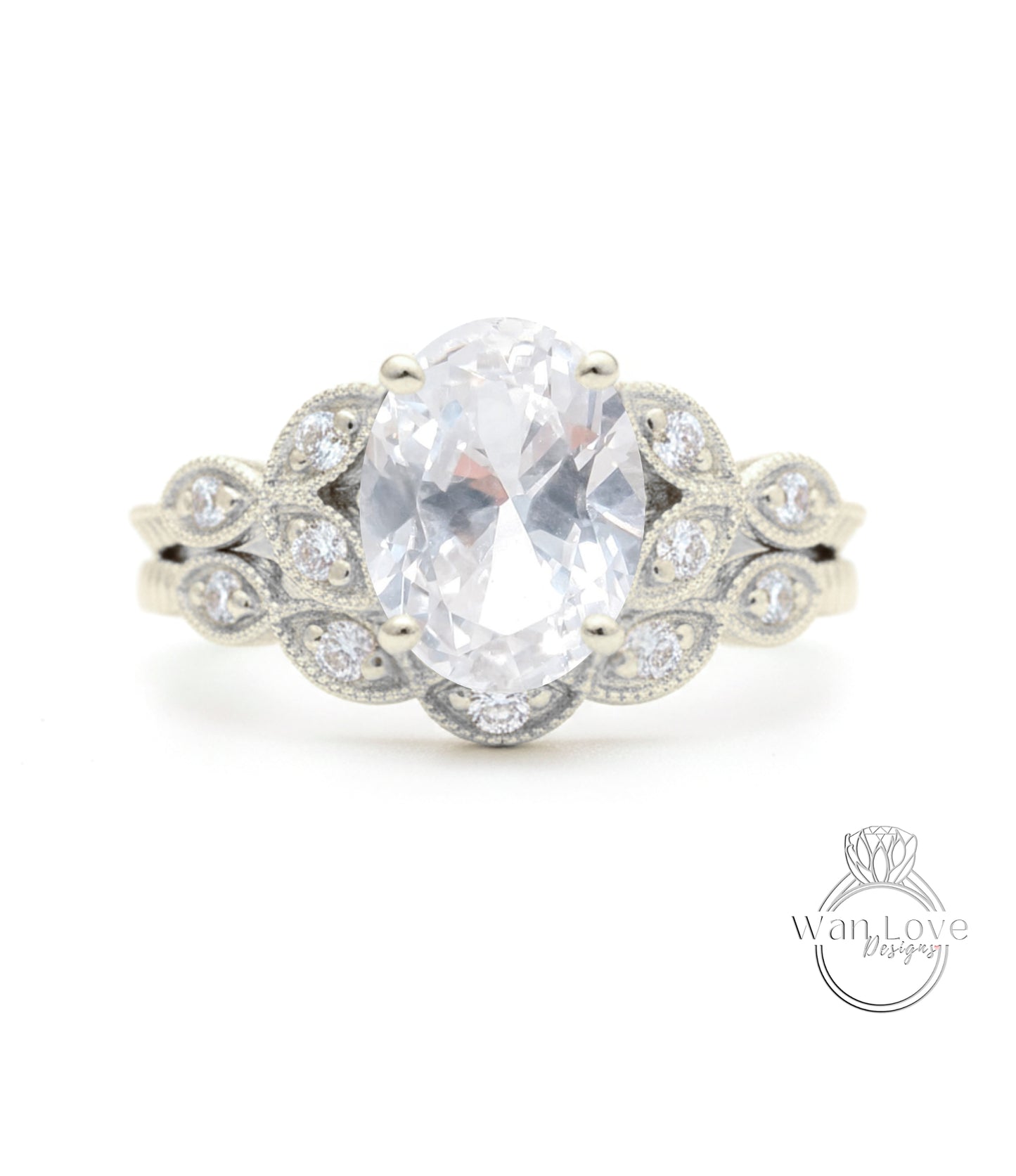 A close-up of a silver ring with a large oval-shaped gemstone, surrounded by smaller diamonds.