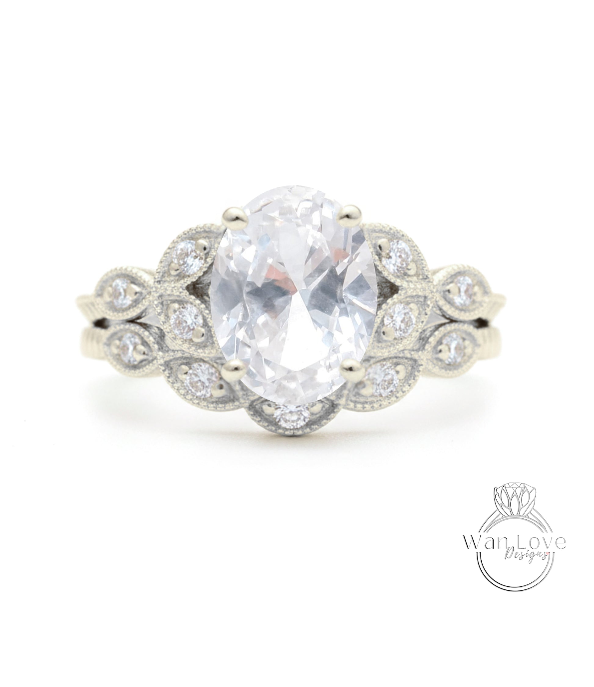 A close-up of a silver ring with a large oval-shaped gemstone, surrounded by smaller diamonds.