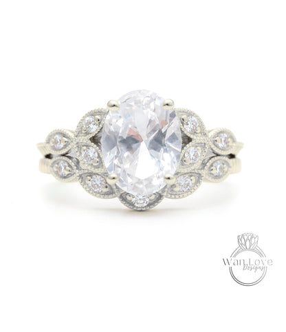 A close-up of a silver ring with a large oval-shaped gemstone, surrounded by smaller diamonds.
