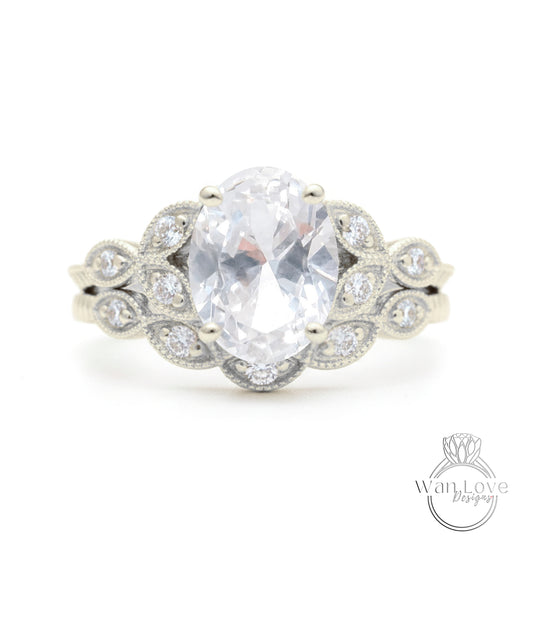 A close-up of a silver ring with a large oval-shaped gemstone, surrounded by smaller diamonds.
