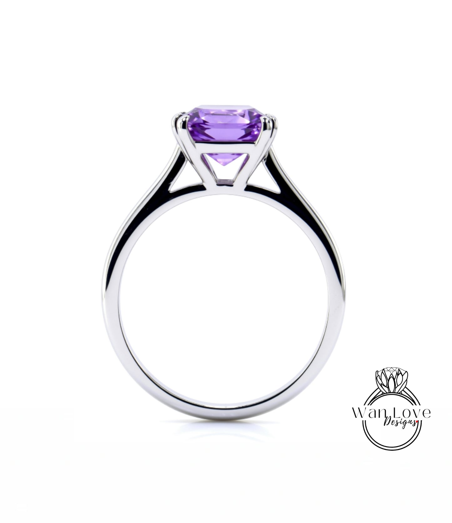 A silver ring with a large purple gemstone, likely an amethyst, set in the center.
