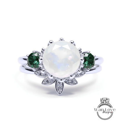 A silver ring with a large oval-shaped gemstone at the center, surrounded by smaller gemstones and a floral design.