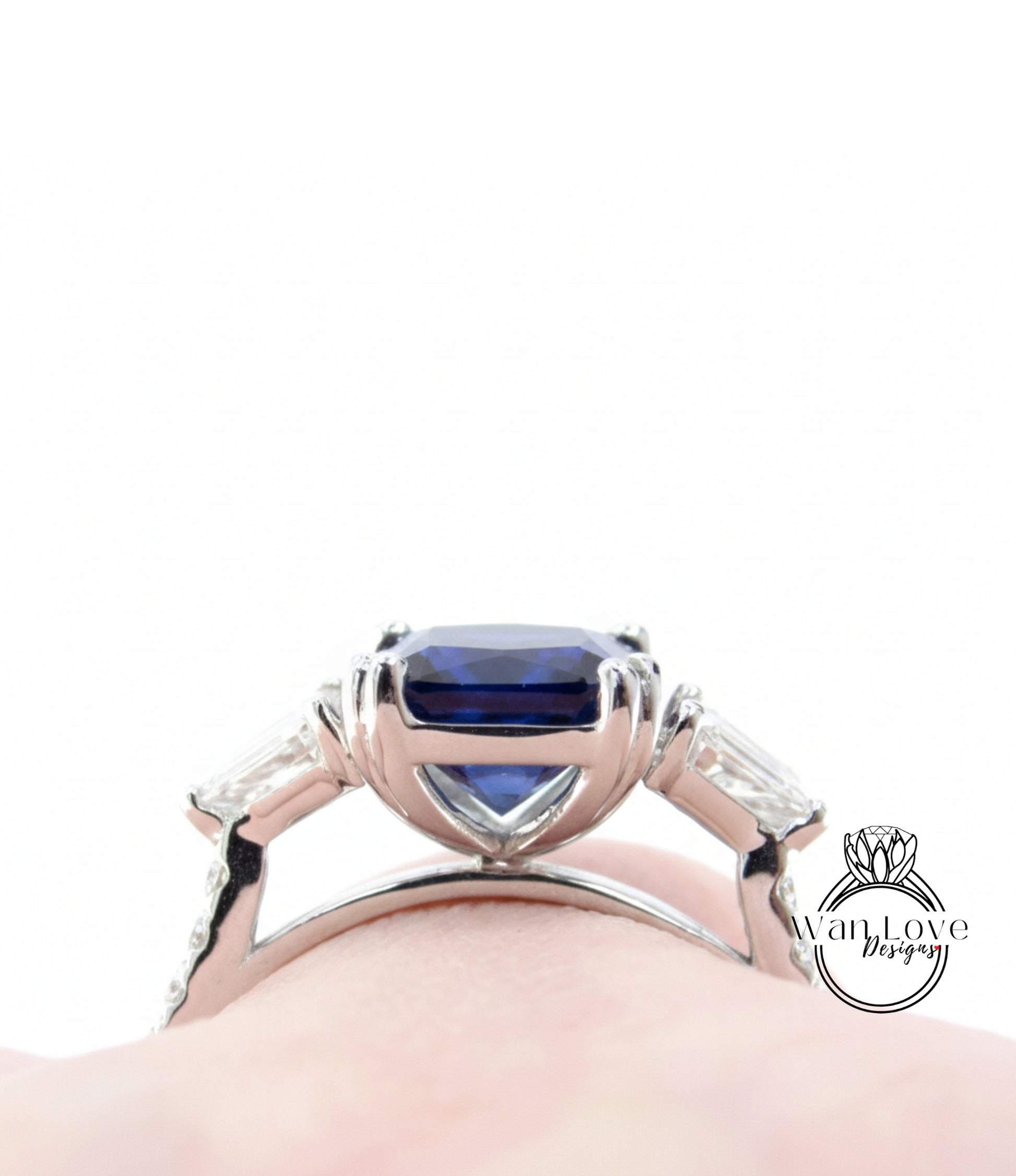 A close-up view of a silver ring with a large blue gemstone, showcasing the intricate design and craftsmanship of the piece.