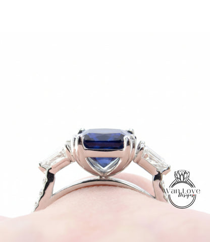 A close-up view of a silver ring with a large blue gemstone, showcasing the intricate design and craftsmanship of the piece.